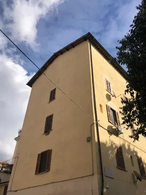 a building with windows on the side of it at All'antico molino in Rome