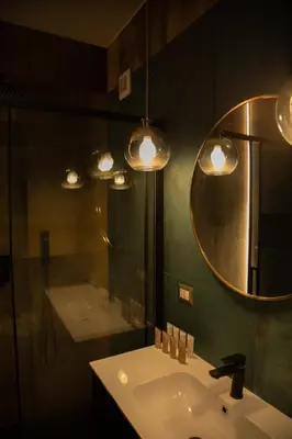 a bathroom with a sink and a mirror and a tub at Riad Campo de' Fiori in Rome