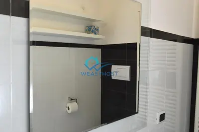a bathroom with a shower with a toilet paper dispenser at Your Roman Retreat near San Giovanni in Rome