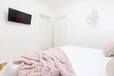 a white bedroom with a pink blanket on a bed at Mosaic Trastevere Silver Apartment in Rome