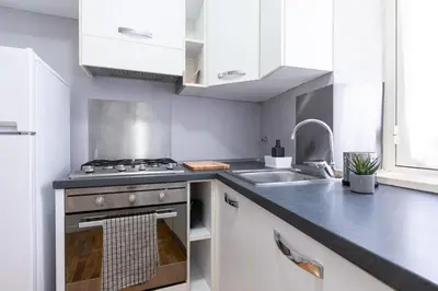 a kitchen with a stove and a sink at Mosaic Trastevere Silver Apartment in Rome