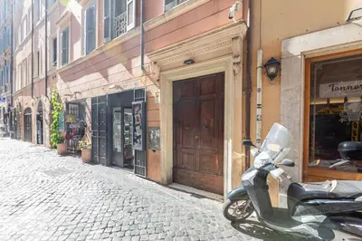 a scooter parked on the side of a street at Mosaic Trastevere Silver Apartment in Rome