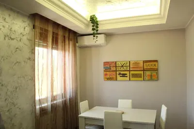 a dining room with a table and a window at Capital House Roma in Rome