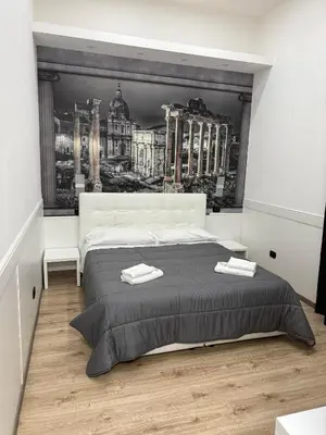 a bedroom with a large bed with two towels on it at FRALE Home in Rome in Rome