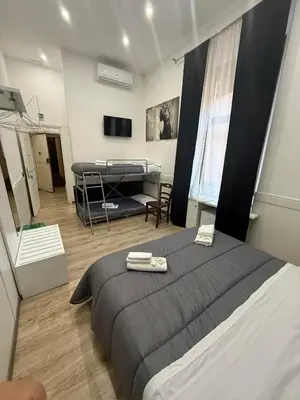 a bedroom with a large bed and a room with a bed sqor at FRALE Home in Rome in Rome
