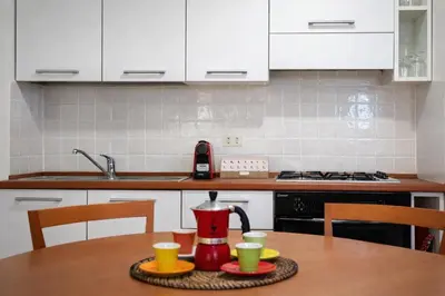 a kitchen counter with a stove top in a kitchen at Peaceful apartment in piazza Venezia's alleys in Rome