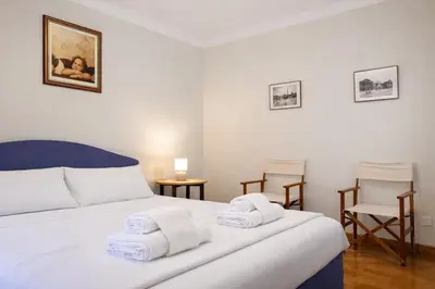a hallway with a staircase leading to a door at Peaceful apartment in piazza Venezia's alleys in Rome