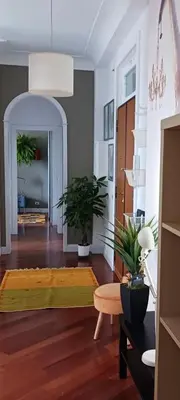 a living room with a table and potted plants at Dimora Qeeboo in Rome