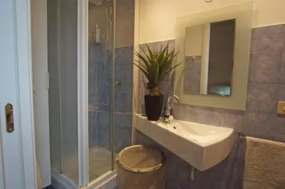 a bathroom with a sink and a shower at Dimora Qeeboo in Rome