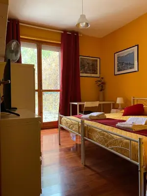a bedroom with two beds and a window at LunaBed Roma - Affitti brevi in Rome