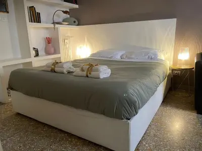 a bedroom with a large bed with towels on it at Fabiola Holiday House in Rome