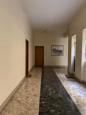 an empty hallway with a door and a tile floor at Fabiola Holiday House in Rome