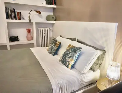 a bed with pillows on it in a room at Fabiola Holiday House in Rome