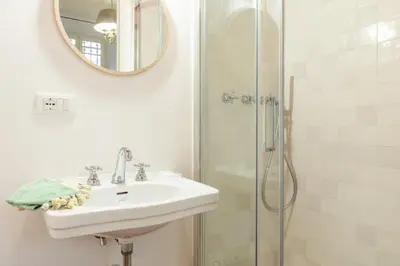 a bathroom with a sink and a shower at Popolo Charming Apartment in Rome