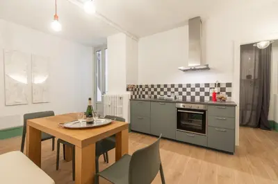 a kitchen and dining room with a table and chairs at Popolo Charming Apartment in Rome