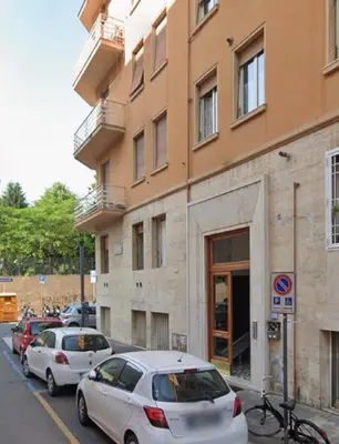 a row of cars parked in front of a building at Living in Vatican City in Rome