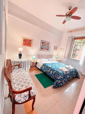 a bedroom with a bed and a chair at Living in Vatican City in Rome