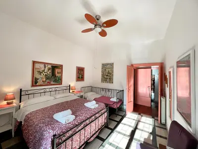 a bedroom with a bed and a ceiling fan at Living in Vatican City in Rome