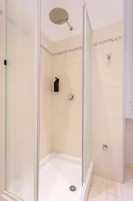 a shower with a glass door in a bathroom at APT Rome 5 BDRMs in Rome