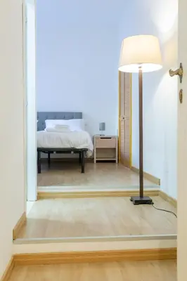 a bedroom with a bed and a floor lamp at APT Rome 5 BDRMs in Rome
