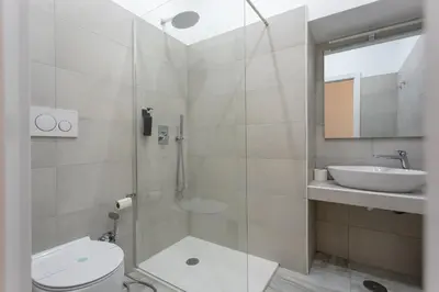 a bathroom with a shower and a toilet and a sink at APT Rome 5 BDRMs in Rome
