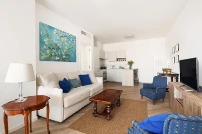a living room with a white couch and a table at Trastevere Contemporary Apartment in Rome