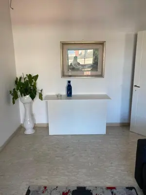 a white table in a room with a picture on the wall at Nic Roma House in Rome