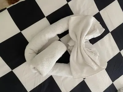 a white towel laying on a black and white floor at Nic Roma House in Rome