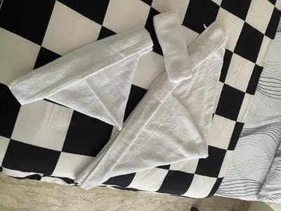 a white comforter on a bed with black and white at Nic Roma House in Rome