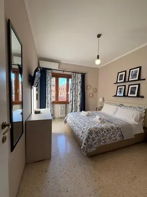 a bedroom with a bed and a dresser and a mirror at Domus Oriana in Rome