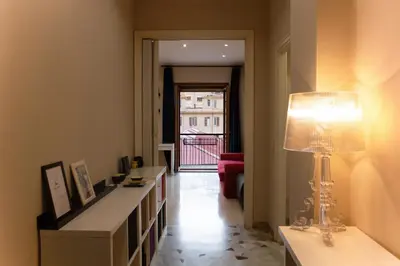 a living room with a table and a lamp in it at Domus Oriana in Rome