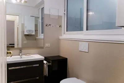a bathroom with a sink and a toilet and a window at Domus Oriana in Rome