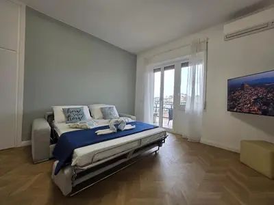 a bedroom with a bed and a large window at Trastevere Dreamer Home Rome in Rome
