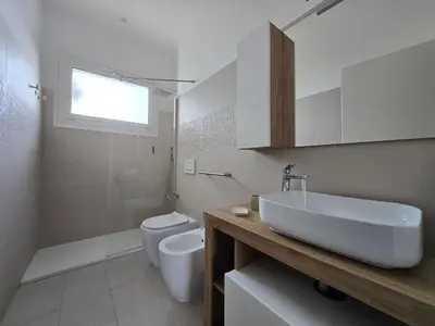 a white bathroom with a sink and a toilet at Trastevere Dreamer Home Rome in Rome