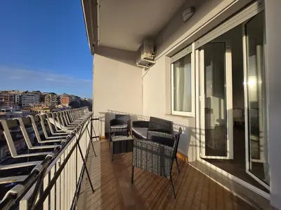 a balcony with chairs and a view of a city at Trastevere Dreamer Home Rome in Rome