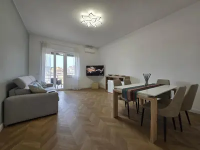 a living room with a dining table and a couch at Trastevere Dreamer Home Rome in Rome