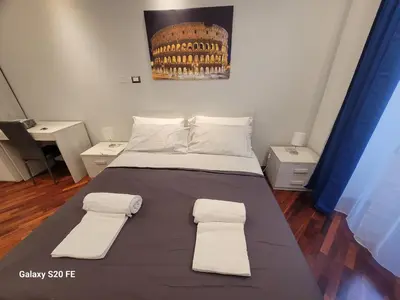 a bed in a room with two towels on it at Vatican house 98 in Rome
