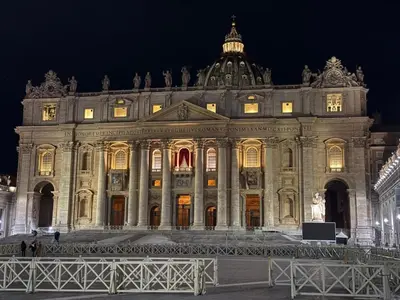 a large building with lights on it at night at Vatican house 98 in Rome