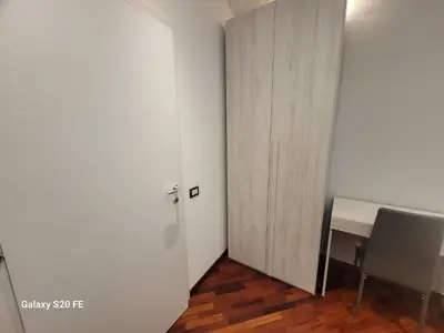 a door in a room with a desk and a chair at Vatican house 98 in Rome
