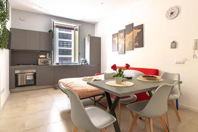 a kitchen and dining room with a table and chairs at Domus Eroi in Rome