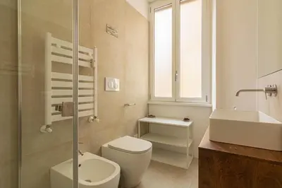 a bathroom with a toilet and a sink and a shower at Domus Eroi in Rome