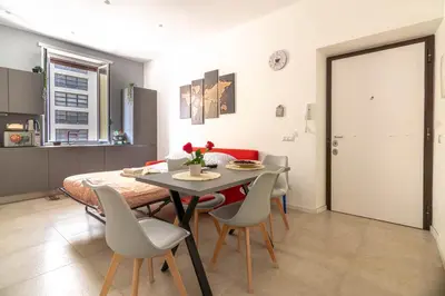 a kitchen and dining room with a table and chairs at Domus Eroi in Rome