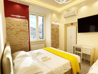 a hotel room with a bed and a television at IMPERIUM INN in Rome