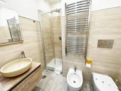 a bathroom with a sink and a toilet and a shower at IMPERIUM INN in Rome