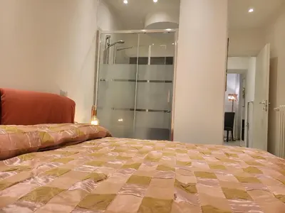a bedroom with a bed and a glass shower at Vatican Tolemaide 2 Suites 2 Bagni in Rome