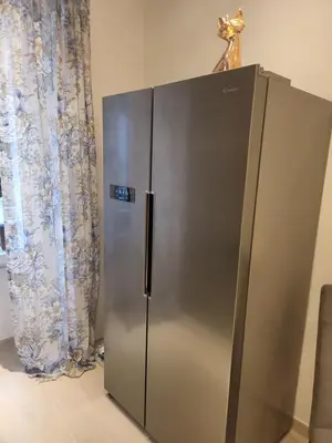 a stainless steel refrigerator with a trophy on top of it at Vatican Tolemaide 2 Suites 2 Bagni in Rome