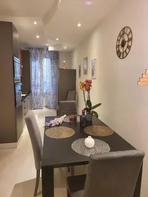 a kitchen and dining room with a table and chairs at Vatican Tolemaide 2 Suites 2 Bagni in Rome