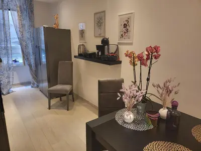 a living room with a table with flowers on it at Vatican Tolemaide 2 Suites 2 Bagni in Rome