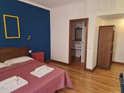 a bedroom with a bed with two towels on it at Pepe's Place - Carlo Alberto in Rome