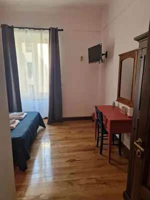 a room with a bed and a table with a mirror at Pepe's Place - Carlo Alberto in Rome